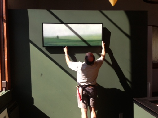 Albert, genius curator and installer, hanging the third to go up.